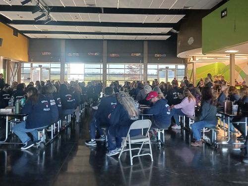 people sitting at tables watching training