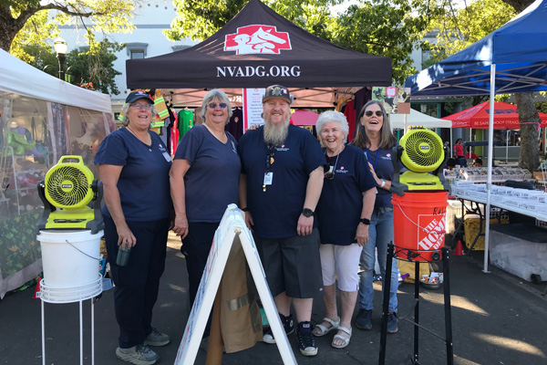 Group of people in front of a booth at an event